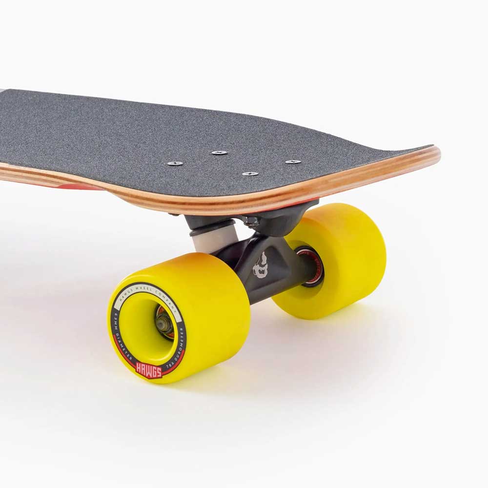 Close-up of the Dinghy Legend Classic Landyachtz Complete Skateboard, featuring a black grip-taped deck with natural wood edges, bright yellow wheels on black trucks, and molded wheel flares, set against a plain white background.
