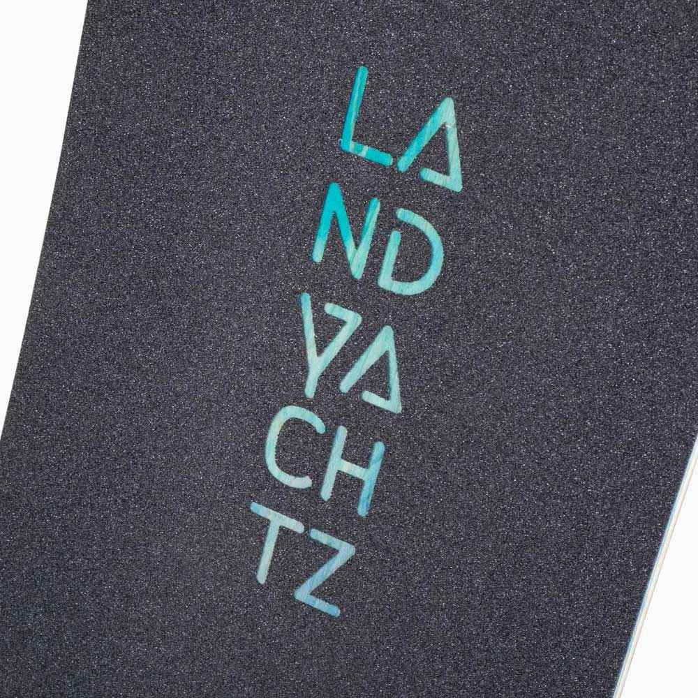 Close-up of the Drop Hammer Octomaze Landyachtz Complete Skateboard grip tape, featuring "LANDYACHTZ" in blue-green letters on textured black—ideal for city commuters.