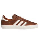 The Brown White Gold Gazelle ADV HQ7547 Adidas Skateboarding suede shoes feature a white sole, heel tab, and three signature white stripes, shown from the side against a white background.