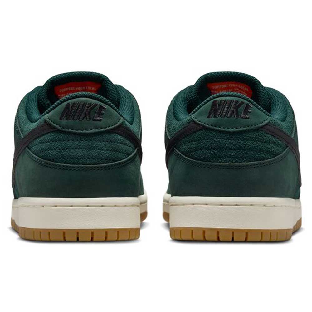 A pair of Dunk Low Pro FJ1674-300 Nike SB sneakers in Deep Fir/Black/Fir/Sail with suede uppers, black Nike logo on the heels, off-white midsoles, and gum rubber outsoles—a modern twist on classic style.