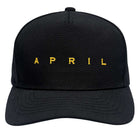 The Embroidered Logo Hat by April Skateboards is an adjustable black cap featuring bold gold "APRIL" lettering across the front.