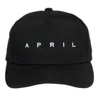 A stylish black adjustable hat from April Skateboards features bold silver embroidered "APRIL" lettering across the front.