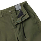 The Eternal Pant Olive Spitfire Wheels features a visible zipper fly, button closure, black drawstring, and a waistband lined with a black-and-white geometric swirl pattern beside the size 32 label—reflecting Spitfire Wheels' iconic style.