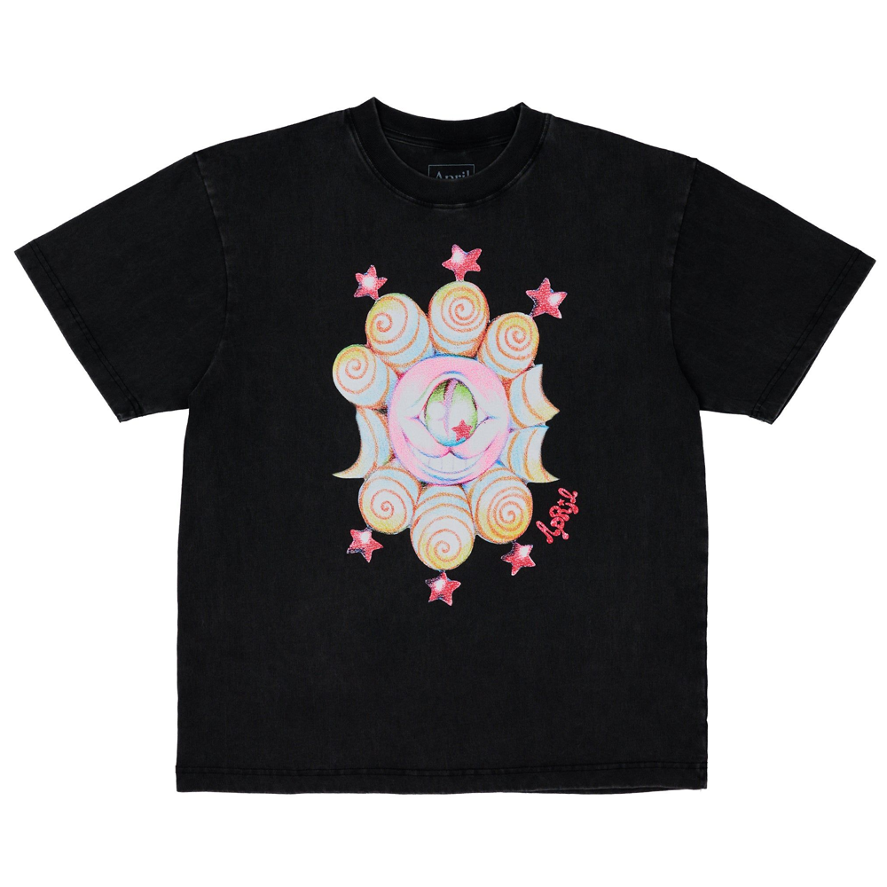 The Eye Tee by Ema Gaspar for April Skateboards is a black heavyweight 100% cotton t-shirt with a colorful surreal print: a crescent moon and eye in the center, swirling patterns, pink stars, and “April” in pink script. Garment dyed for softness.
