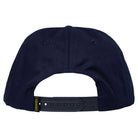 The image shows the back view of the Eyes Navy Blue Snapback by Krooked Skateboards, featuring an adjustable black snapback closure and a small yellow tag on the left side.