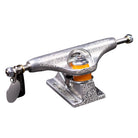 A close-up of an FA x INDY 169 Hollow Polished Burnt Logo Stage 11 truck, featuring detailed engravings, orange bushings, and a metal tag attached to one end, displayed against a white background.