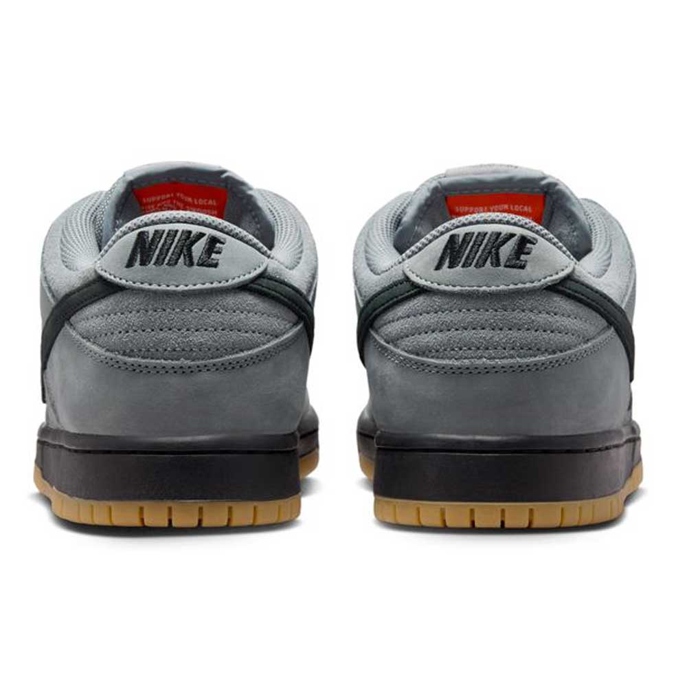 The FJ1674002 Cool Grey Black Nike SB Dunk Low Pro Suede Shoes feature gray suede uppers, black NIKE branding on the heels, black midsoles, light brown gum outsoles, and a lighter gray inner lining for classic style and timeless appeal.