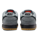 The FJ1674002 Cool Grey Black Nike SB Dunk Low Pro Suede Shoes feature gray suede uppers, black NIKE branding on the heels, black midsoles, light brown gum outsoles, and a lighter gray inner lining for classic style and timeless appeal.