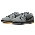 The FJ1674002 Cool Grey Black Nike SB Dunk Low Pro Suede Shoes feature gray suede, black swooshes and midsoles, and gum outsoles, shown from a front-side angle on a white background—ideal for classic sneaker fans.