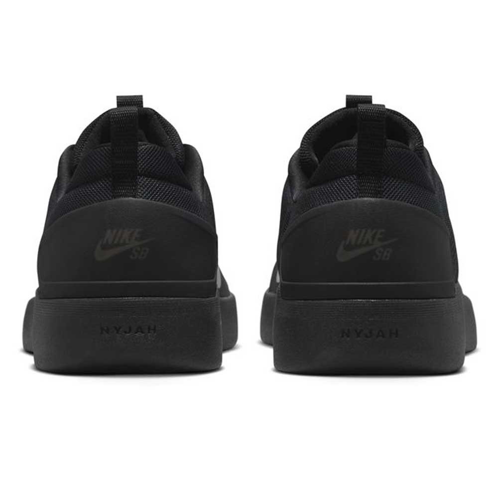 The FQ1273-002 Black White Zoom Nyjah 4 Nike SB Skateboarding Shoes feature a black mesh upper for durability, NIKE SB branding on the heels, NYJAH embossed on the midsole, and are shown from the back.