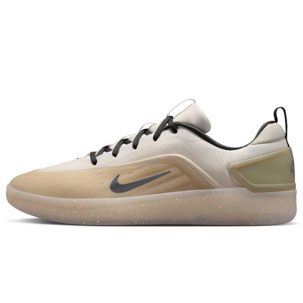 The FQ1273-200 Khaki White Zoom Nyjah 4 Nike SB Skateboarding Shoes feature a beige and white design with a black swoosh, black laces, translucent speckled sole, Air Zoom cushioning, and a reinforced mesh upper for durability.