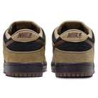 A pair of Filbert Light Chocolate Black Burgundy Ash Dunk Low Pro HQ1625201 Nike SB Skateboarding Shoes viewed from the back, featuring brown, black, and tan suede with NIKE embroidered in maroon on the heel tabs—perfect for fans of classic sneakers.