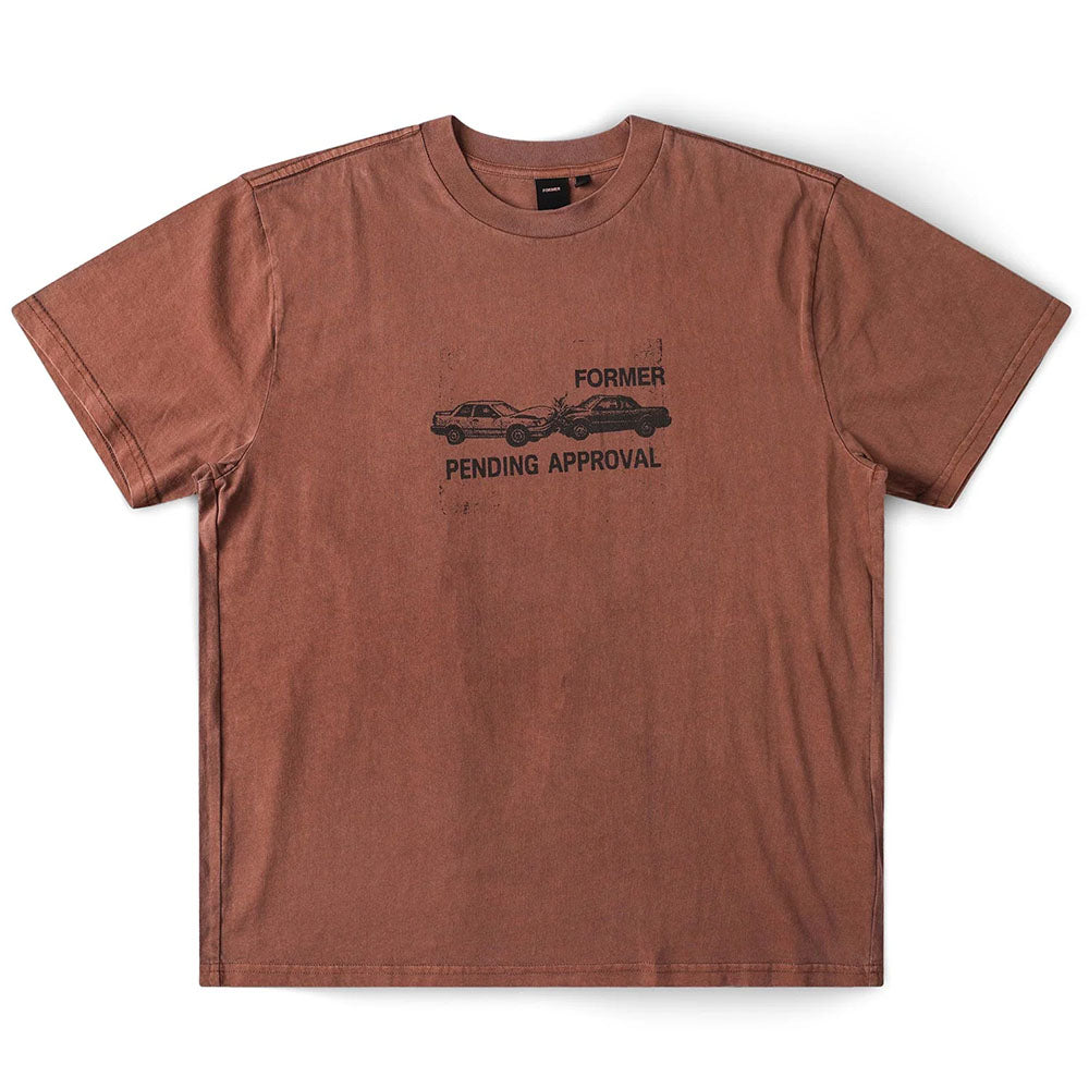 The Fork in the Road Former Tee Washed Bark is a brown, short-sleeve vintage T-shirt made from premium jersey cotton for comfort and style. It features a black screen-printed graphic of two cars crashing, with “FORMER” displayed above and “PENDING APPROVAL” below the image.