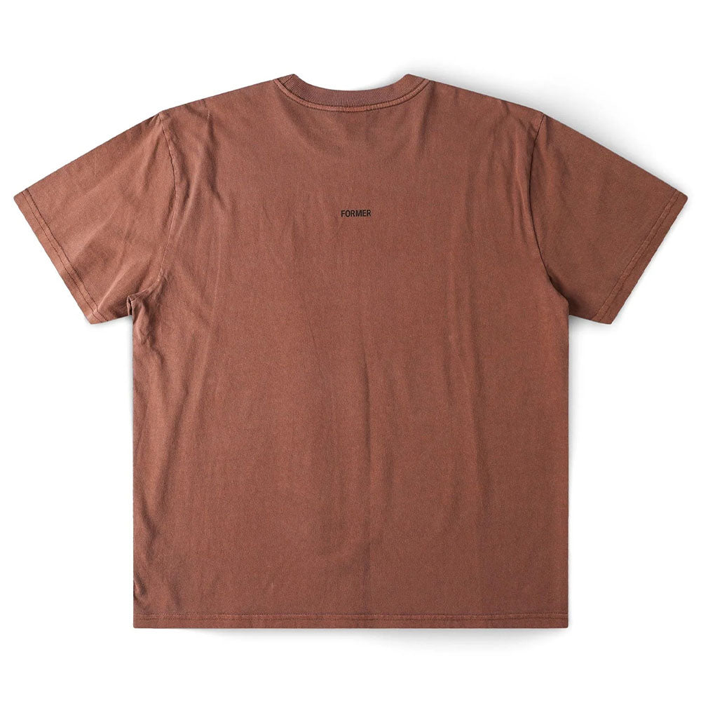 The Crux Overdye Former Tee in Washed Bark is a premium jersey cotton short-sleeve t-shirt, shown from the back and laid flat on a white background. The word “FORMER” appears in small black letters at the upper center.