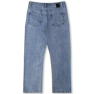 A pair of Crux Denim Pant Washed Blue Former jeans shown from the back, featuring a classic straight fit silhouette, two rear pockets, and a black leather patch on the waistband. Crafted from 100% cotton denim for lasting comfort and durability.