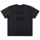 Crux Overdye Former Tee Washed Black: A premium 200GSM cotton short-sleeve T-shirt in washed black, featuring a subtle, dark embossed design of two overlapping circular patterns on the chest. Shown laid flat on a white background.