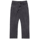 A pair of Crux Denim Pant Washed Black Former jeans, crafted from 100% cotton denim with a straight-leg silhouette, button and zip fly, front and back pockets, and copper rivet details, laid flat on a white background.