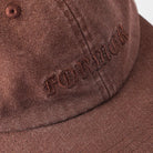 A close-up of the Alleviate Cap Former Hat Bark, a brown fabric baseball cap featuring the word FOREVER embroidered in dark brown gothic-style letters on the front, reminiscent of a bold vintage T-shirt screen print.