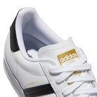 Close-up of GW6930 White Black Superstar ADV adidas Skateboarding Leather Shoes with black stripes, gold adidas branding on the tongue, SUPERSTAR in gold on the side, white laces, and a textured rubber sole.