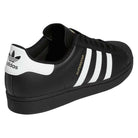 The GW6931 Black White Superstar ADV Adidas Skateboarding Leather Shoes feature a black leather upper, white stripes, white heel tab with the Adidas logo, "SUPERSTAR" in gold beside the stripes, black sole, and black laces.