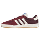 Side view of the Glenburn Burgundy White KJ5048 adidas skateboarding shoes featuring maroon uppers with classic white stripes, a white heel, gum sole, and a blue logo on the tongue—these sneakers blend timeless skate style with all-day comfort.