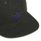 A close-up of the Gonz Cap Black Blue KS6799, an adjustable Adidas hat with a blue embroidered stylized bird logo on the front panel. The brim and stitching are prominently visible.