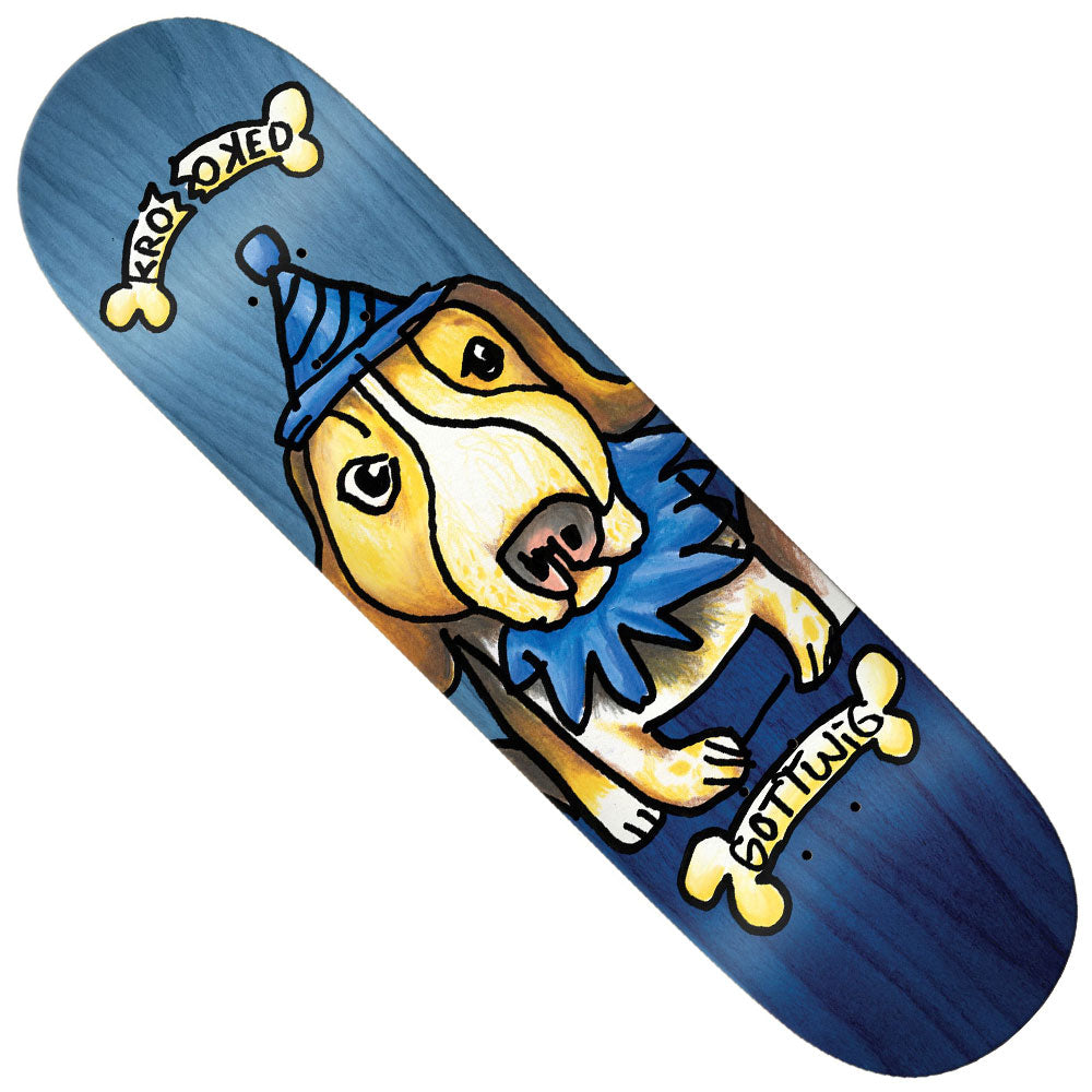 The Gottwig Blueberry 8.25x32 Krooked Skateboards Deck showcases a playful cartoon dog in a blue party hat and collar, surrounded by three yellow bones labeled “Krooked,” “Bottung,” and “OKed,” all set on a blueberry-toned blue wood background—blending fun design with classic skate style.