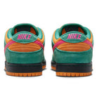 The Nike SB Dunk Low Pro "Green Noise Watermelon Light Curry" (HQ1625301) features a leather upper, green suede heels, orange panels, pink NIKE branding, and pink accents above a black midsole and gum outsole.