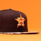 The Old Head RTC Wood Oil Houston Astros New Era Hat 5950 Fitted is a black cap with an orange star and white H logo on the front, featuring a flat patterned brim for a bold style.