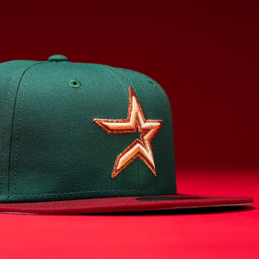 A La Virgencita Green Red Gold New Era Houston Astros 5950 Fitted Hat, featuring a shiny gold and orange star emblem on the front inspired by Mexican culture, set against a vibrant red background.