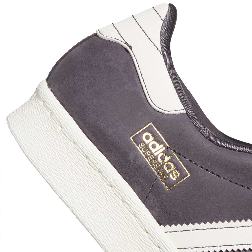 Close-up of the Grey White Superstar 80 ADV HQ9289 Adidas Skateboarding Leather Shoes, featuring gray leather with white stripes, textured white midsole, and gold SUPERSTAR logo—classic adidas style meets skate-ready durability.