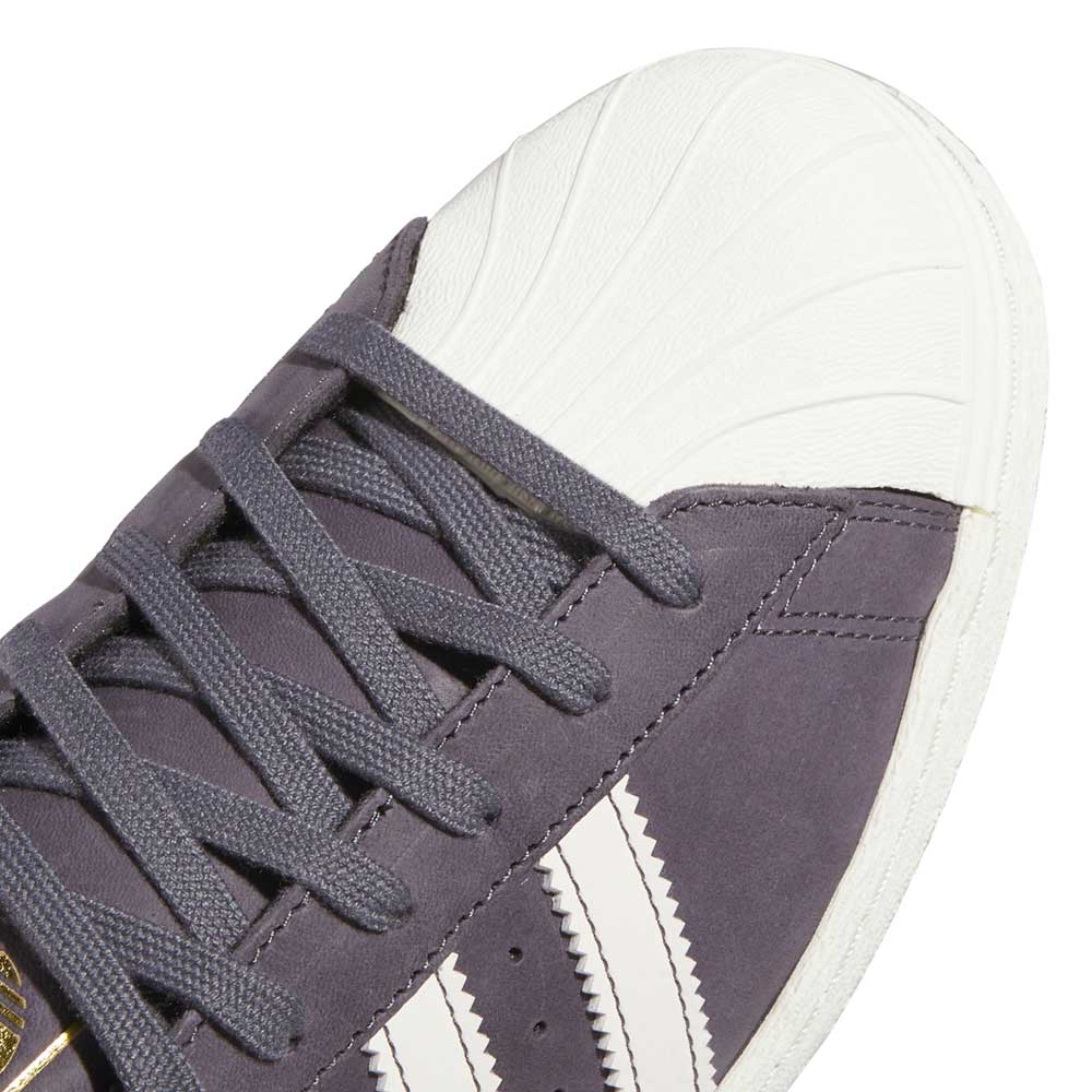 Close-up of Grey White Superstar 80 ADV HQ9289 Adidas Skateboarding Leather Shoes with a white rubber shell toe, white stripes, gray laces, stitched detailing, and classic skate shoe design.
