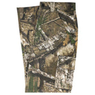 Groundwork 2 Cargo Pants Realtree APX Bottom Mens Independent, featuring a classic REALTREE camouflage pattern in green, brown, and tan with tree and leaf designs, shown folded and laid flat on a white background.