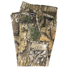 A pair of folded Groundwork 2 Cargo Pants Realtree APX Bottom Mens by Independent, crafted from durable camouflage ripstop fabric with multiple cargo pockets and a visible INDEPENDENT label above one back pocket, displayed on a white background. This rugged apparel piece showcases the authentic REALTREE APX colorway for versatile outdoor style.