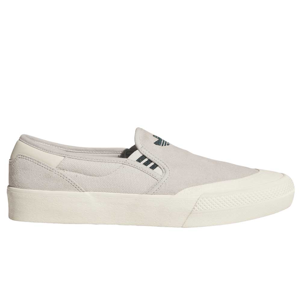 The HQ4721 Gray White Shmoofoil Slip RX Adidas Skateboarding suede shoes feature a light gray slip-on design, white rubber sole, elastic side panels, subtle stitching, and a small black Adidas logo—perfect for everyday casual wear.