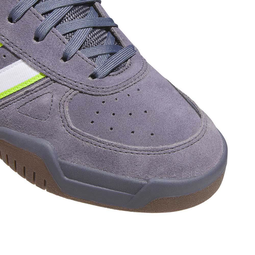 Close-up of the HQ4813 Gray White Green Tekkira Adidas Skateboarding Suede Shoe, featuring blue laces, a suede upper, white and green side stripe detail, and a textured rubber sole.