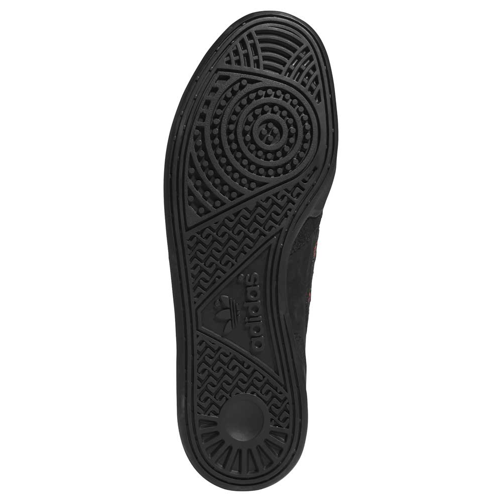 The image shows the black rubber sole of the Handball Top x Mike Arnold Core Black Suede Adidas Skateboarding Shoes, featuring textured grip patterns and the adidas skateboarding logo embossed near the center.