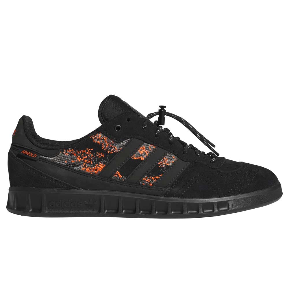 The Handball Top x Mike Arnold Shoes are black Adidas Skateboarding shoes in suede and mesh with orange and gray speckled details, black laces, and a thick black sole.