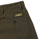 Close-up of Hecho Por Skate Pant Anti Hero Skateboards in Dark Olive, featuring a back pocket with button and eagle patch—ideal for skateboarding and perfect for exclusive Skateshop Day releases.