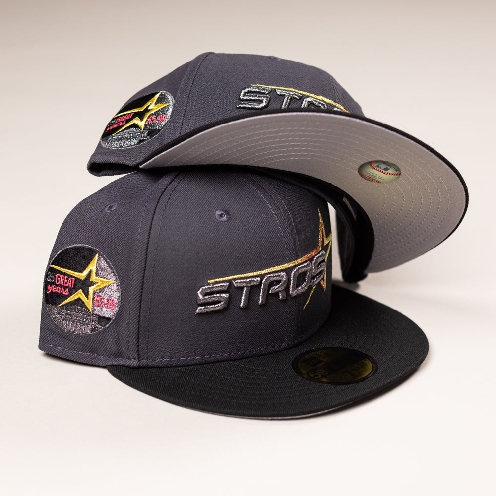 Two Black Delta City Connect Houston Astros New Era Hat 5950 Fitted caps stacked, featuring the word ASTROS in gold and silver embroidery and a 35 Great Years star patch on the side.