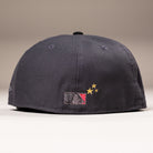 Back view of a black Delta City Connect Houston Astros New Era Hat 5950 Fitted, featuring a Major League Baseball logo with a red panel and two gold embroidered stars.
