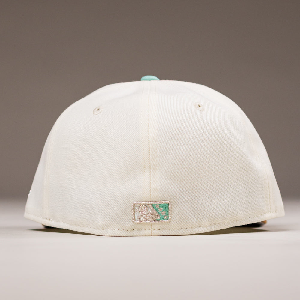 The Hookset Corpus Christi Hooks New Era Hat 5950 Fitted is shown from the back with an embroidered team patch and a teal top button, set against a plain neutral background.