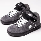 A pair of Grasshopper Gray Suede I Path Shoes for skateboarding, featuring black soles, white laces, and velcro straps. These sneakers display a white puzzle piece logo on the side and tongue, subtle IPATH branding, and are shown against a white background.