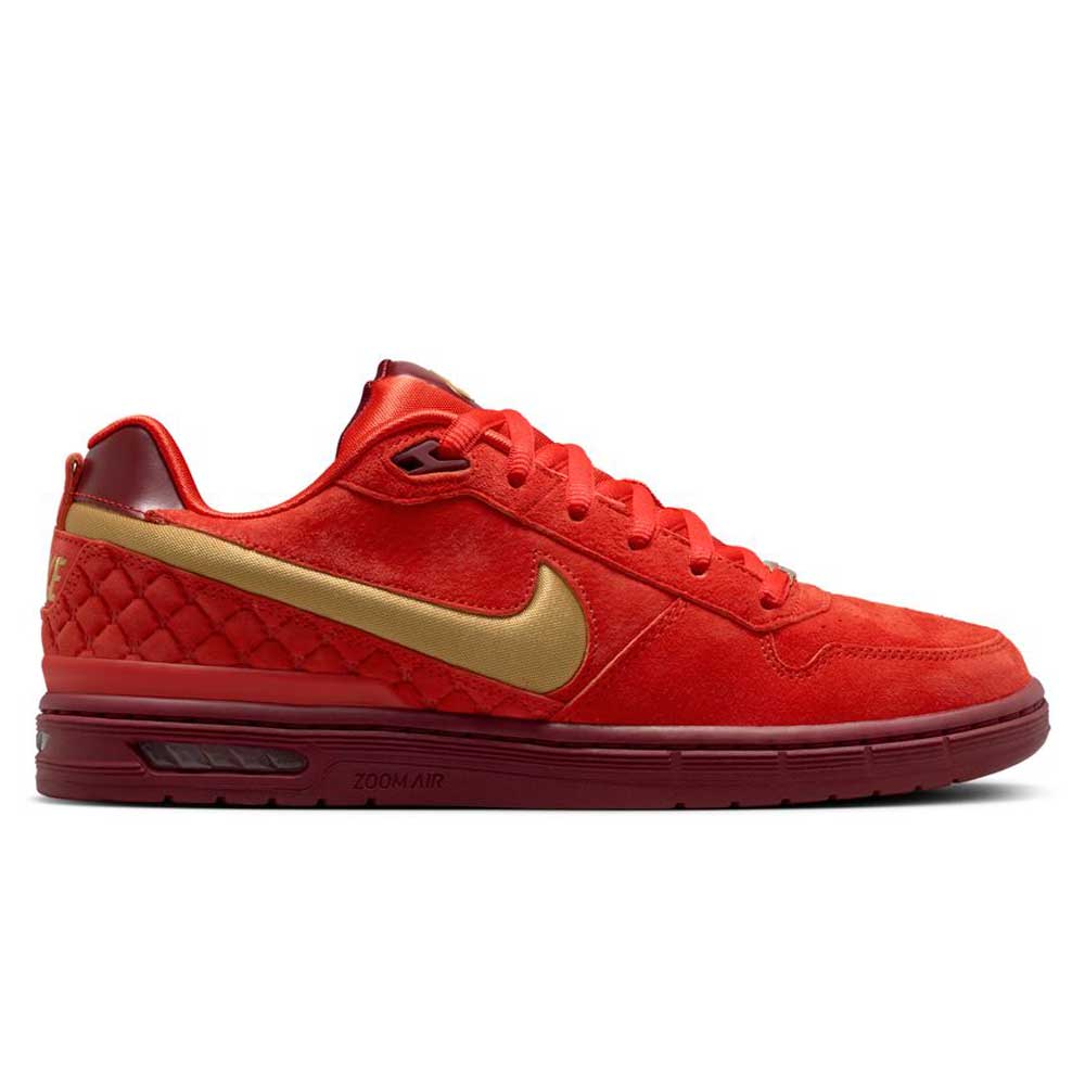 The Nike SB Paul Rodriguez Zoom Air Low features a Habanero Red suede upper, Club Gold Swoosh, quilted heel detailing, Team Red midsole, and Zoom Air cushioning for stylish comfort and support with every step.