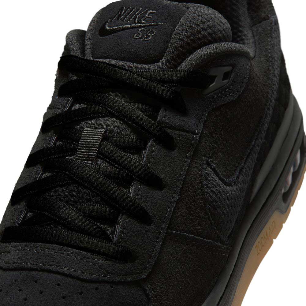 Close-up of the IQ6827001 Black Gum Light Brown Paul Rodriguez Zoom Air Low Suede Skateboarding Shoe, highlighting black laces, tongue with Nike SB branding, suede and mesh upper, leather details, and a gum-colored sole.