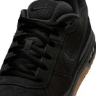 Close-up of the IQ6827001 Black Gum Light Brown Paul Rodriguez Zoom Air Low Suede Skateboarding Shoe, highlighting black laces, tongue with Nike SB branding, suede and mesh upper, leather details, and a gum-colored sole.