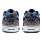 Back view of IU7835001 Flint Grey Deep Royal Blue Paul Rodriguez Zoom Air Low Suede Skateboarding Shoes showing gray suede with blue accents, white soles, and NIKE embroidered in blue on the heels plus a textured lower heel pattern.