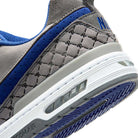 Close-up of the heel of the IU7835001 Flint Grey Deep Royal Blue Paul Rodriguez Zoom Air Low Suede Skateboarding Shoes, showing a suede upper, textured design, visible Zoom Air cushioning, detailed stitching, deep-groove outsole, and partially visible branding.
