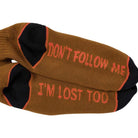 I'm Lost Too Brown Orange Black Anti Hero Socks feature black toes and heels. One sock says "DONT FOLLOW ME," the other "I'M LOST TOO" in orange-red—perfect for those who walk their own path.