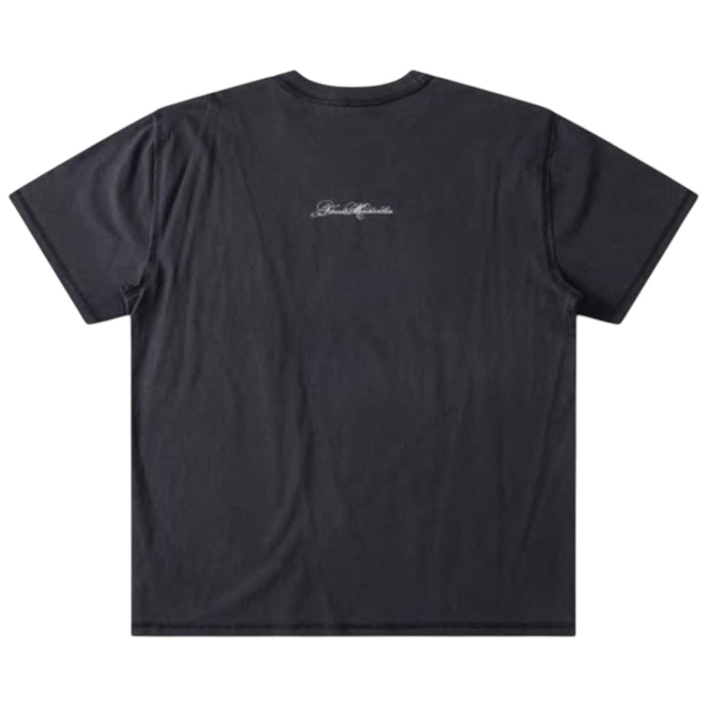 The Illusion Former Tee Washed Black is laid flat, featuring short sleeves and a premium cotton construction. Small white cursive text is screen printed and centered near the upper back, with no other visible designs.